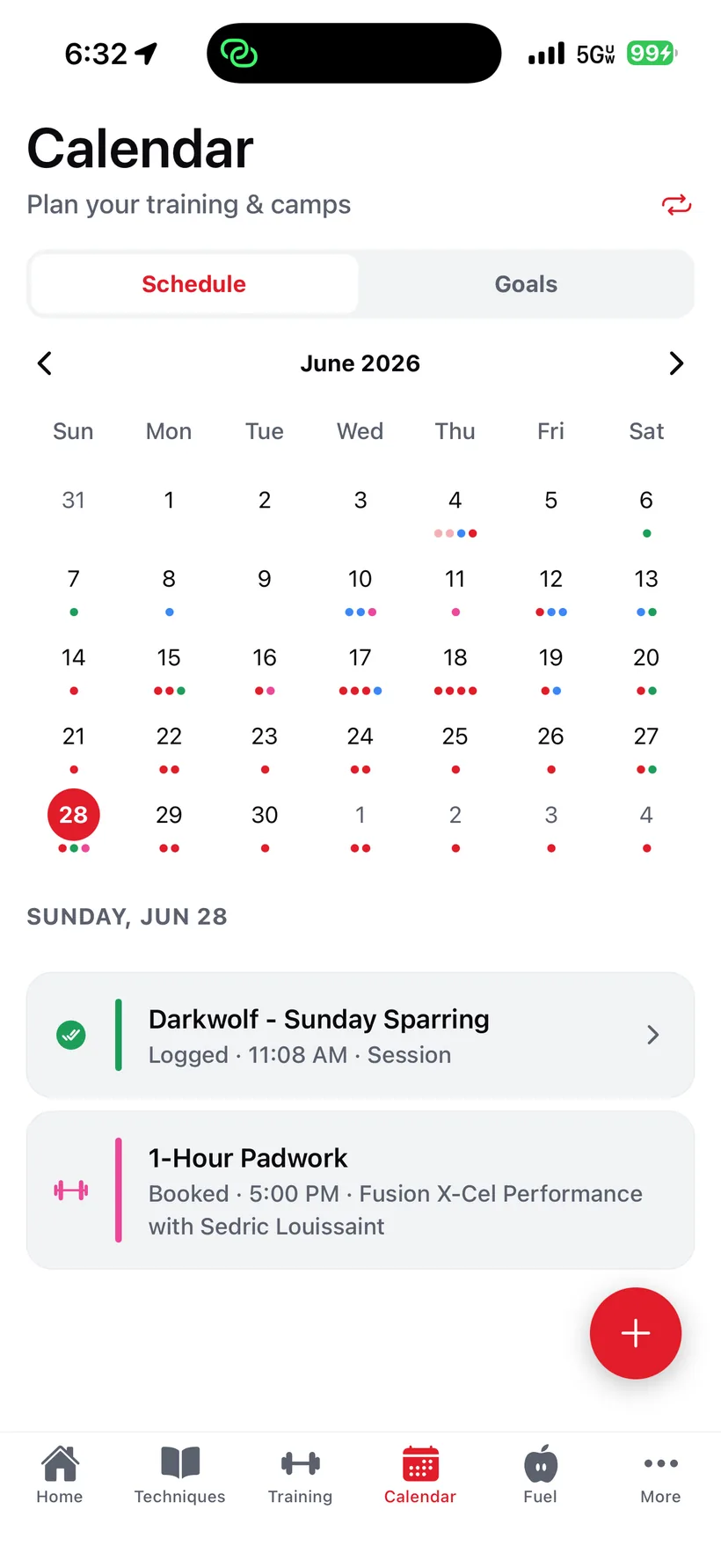 The iVenza calendar: a month view of training and camps with a logged sparring session and a booked padwork lesson.